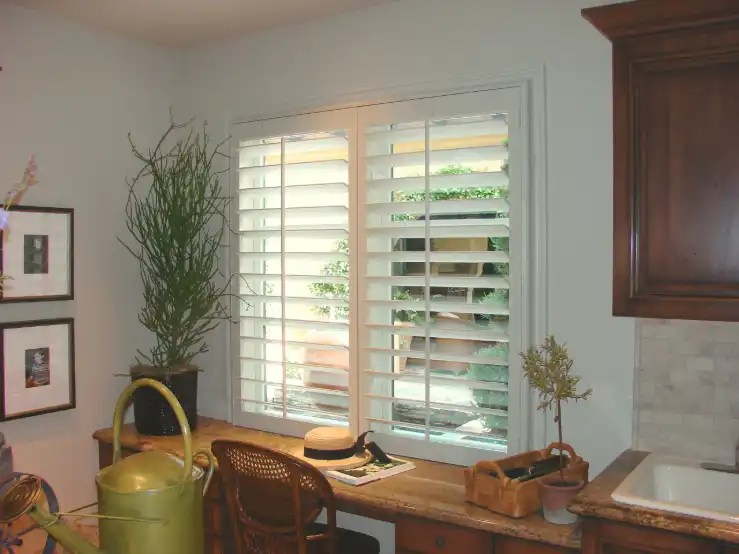White wooden shutters in a bright Orange County home office