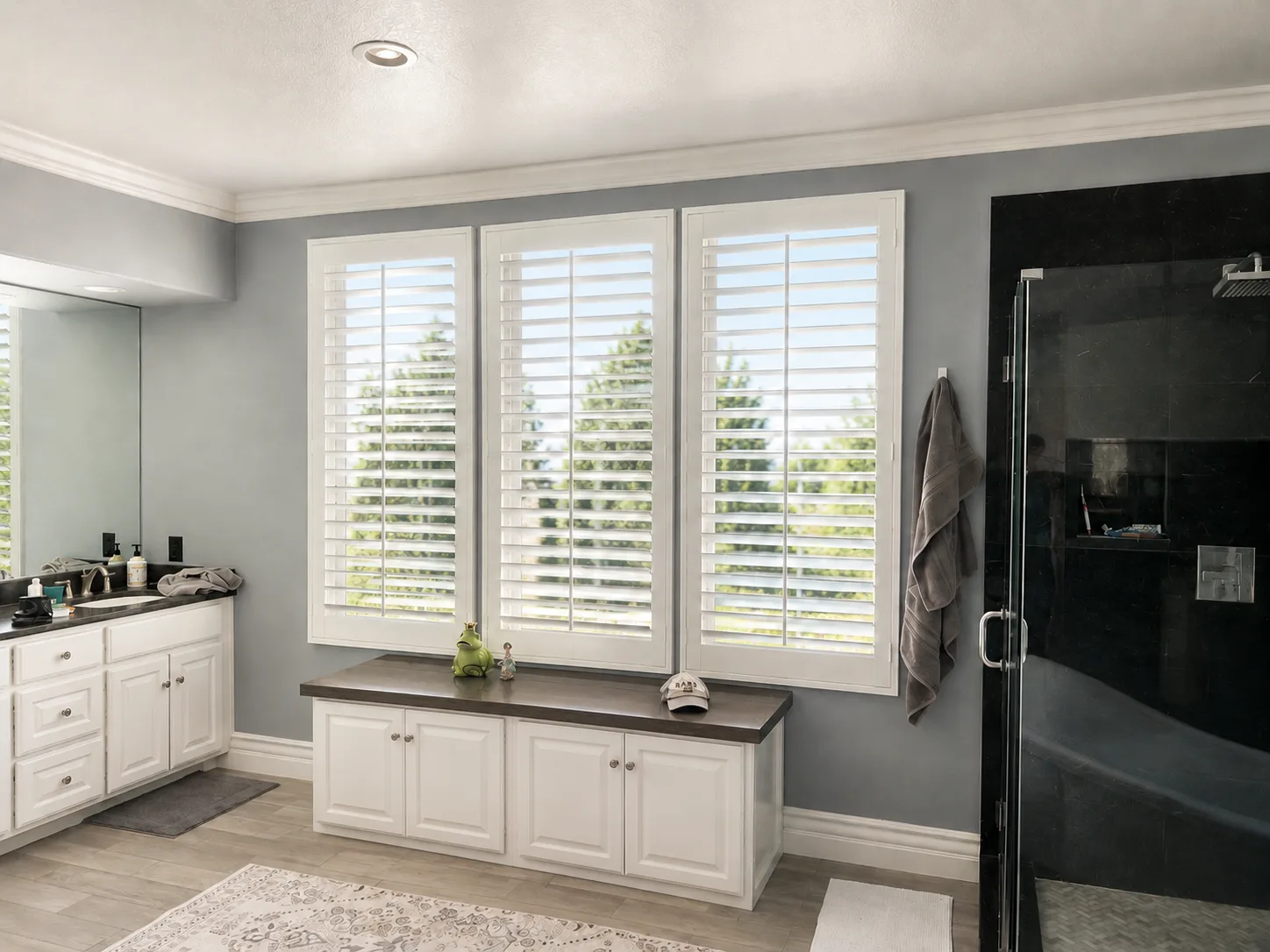 White poly plantation shutters across three windows in a Foothill Ranch master bath