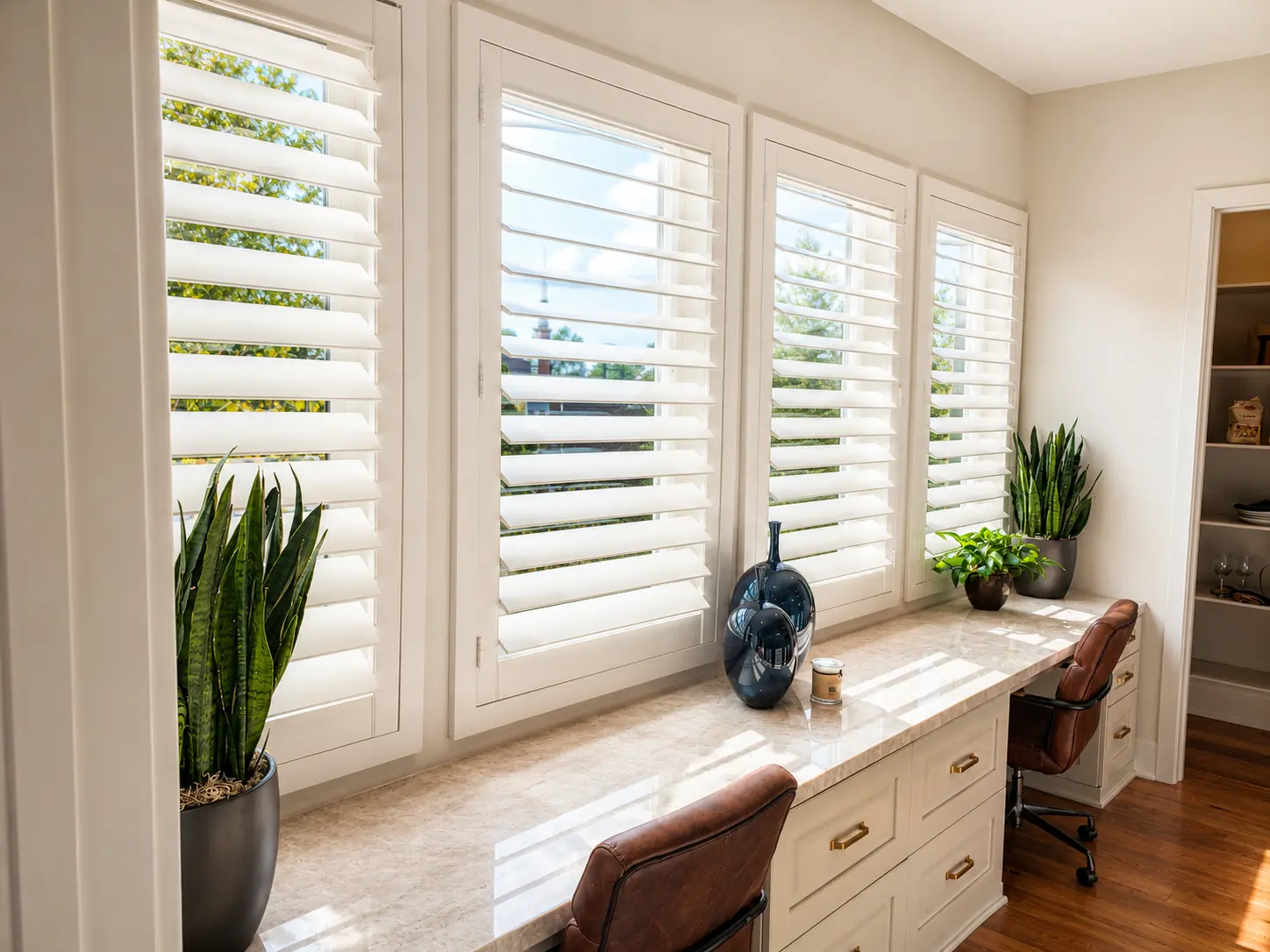 White plantation shutters above a built-in desk in a finished Tustin home office