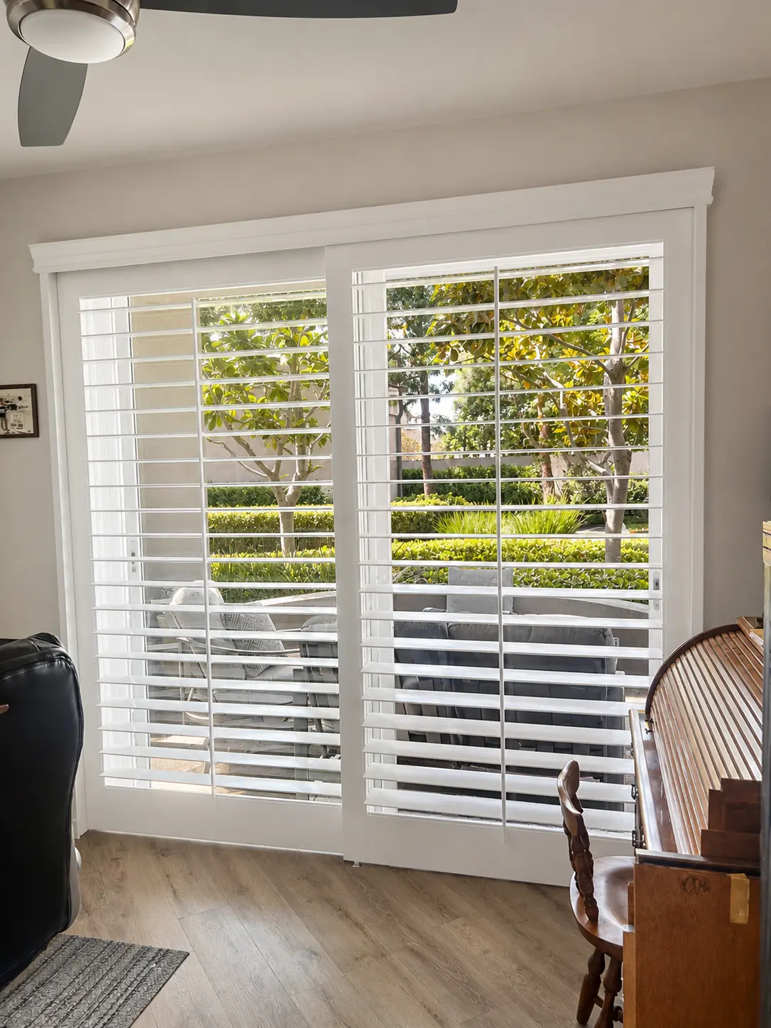 White plantation shutters across a patio slider in a living room