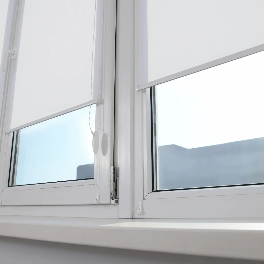White solar shades filtering sunlight over windows with a view kept in an Orange County room
