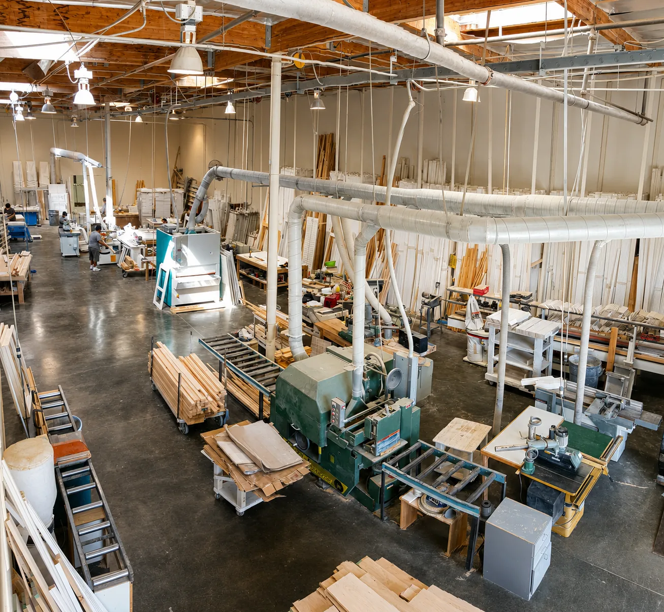 Golden West factory floor in Lake Forest with woodworking machinery and basswood shutter parts